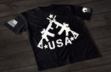 Black USA rifle T-shirt featuring crossed rifle graphic forming a patriotic American flag style design with stars on the front